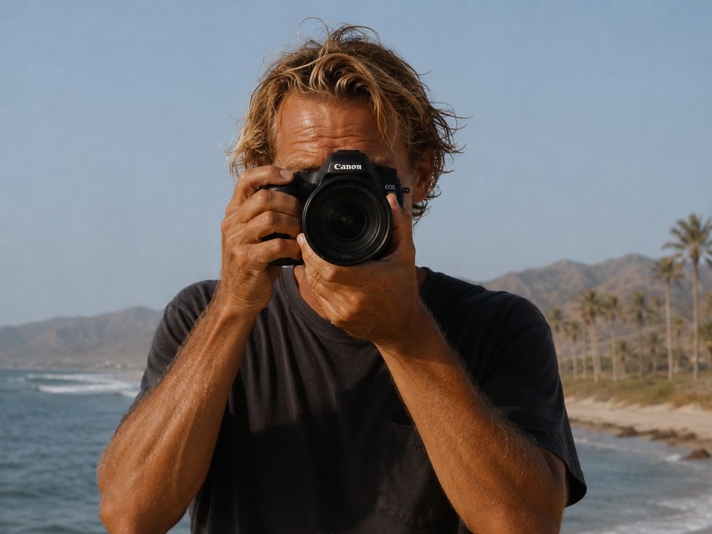 A local Baja photographer on the beach, camera in hand